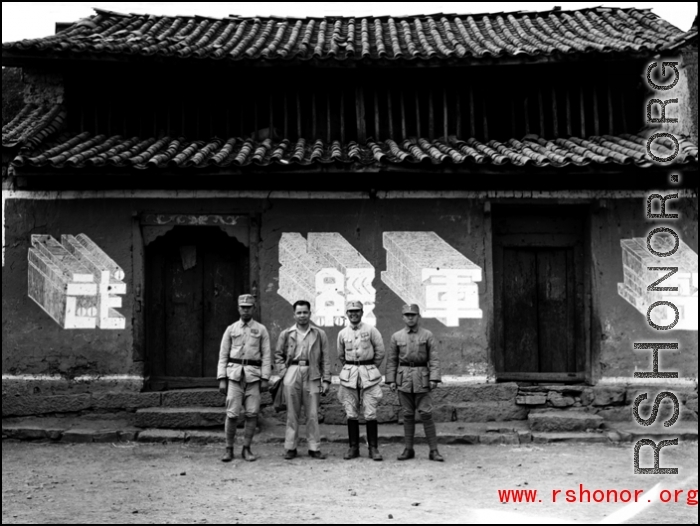Chinese soldiers in the CBI stand before building with a slogan 整军经武 (roughly "build up the military")  in Yunnan province, China.