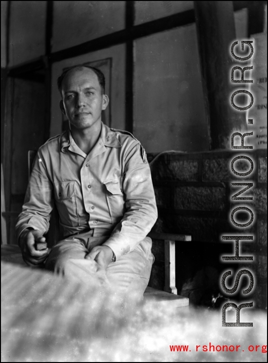 A GI sits and poses in a club in the CBI during WWII.    From the collection of David Firman, 61st Air Service Group.