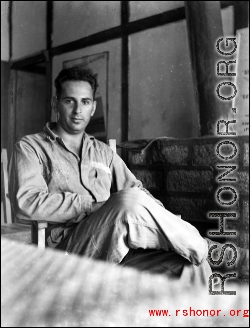 A GI sits and poses in a club in the CBI during WWII.    From the collection of David Firman, 61st Air Service Group.