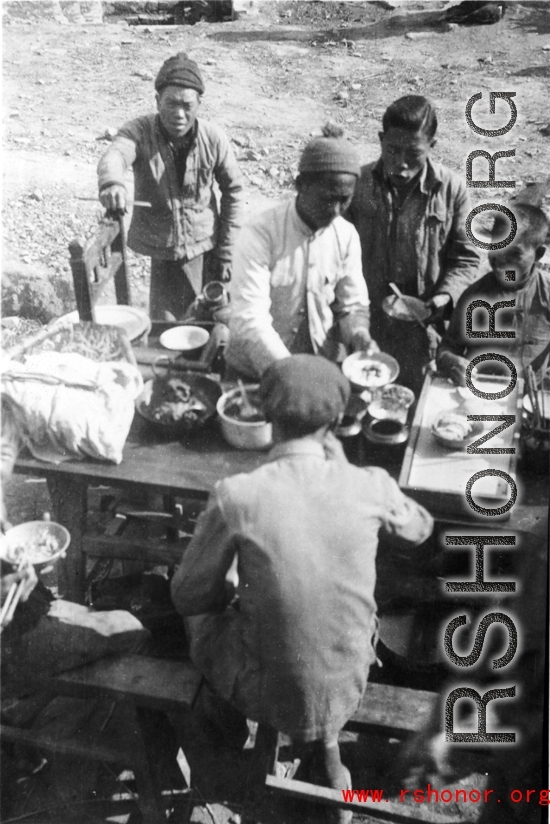 Chinese civilians eat a nice meal in the CBI during WWII.