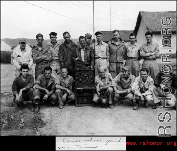 "Communications ground maintenance." Men of the 27th Troop Carrier Squadron surround a large radio unit with tall antenna in the CBI (most likely China).