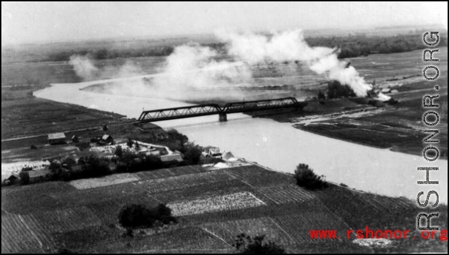 An aerial photograph during battle in the CBI--The approach to a railway bridge in SW China or Indo-China has been bombed by a plane of 491st Bomb Squadron, 341st Bombardment Group.