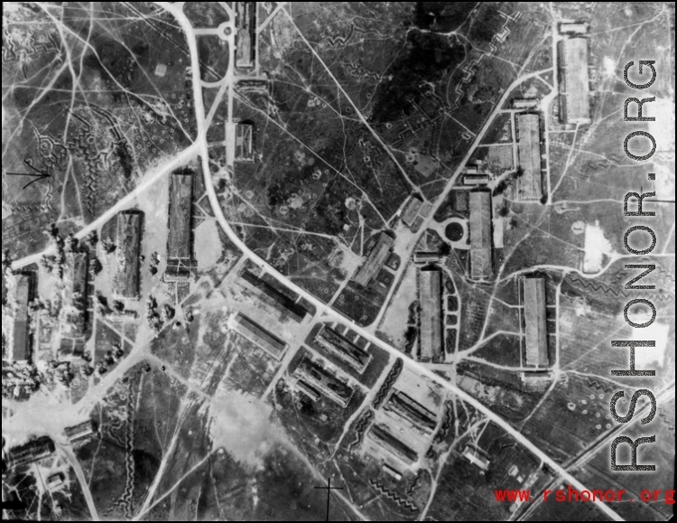 An aerial reconnaissance photograph shAn aerial reconnaissance photograph showing an enemy base in the midst of bombing, and zig-zag trenches on the ground, in the CBI during WWII. an enemy base in the midst of bombing.