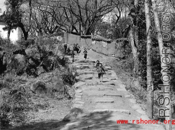 Kids run on a village path at a village near Yangkai, Yunnan province, China, during WWII.
