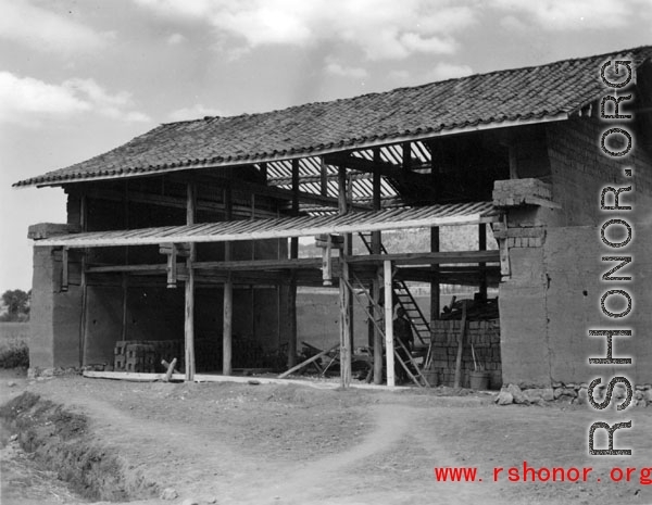 A house under construction in a village in Yunnan province, China. During WWII.