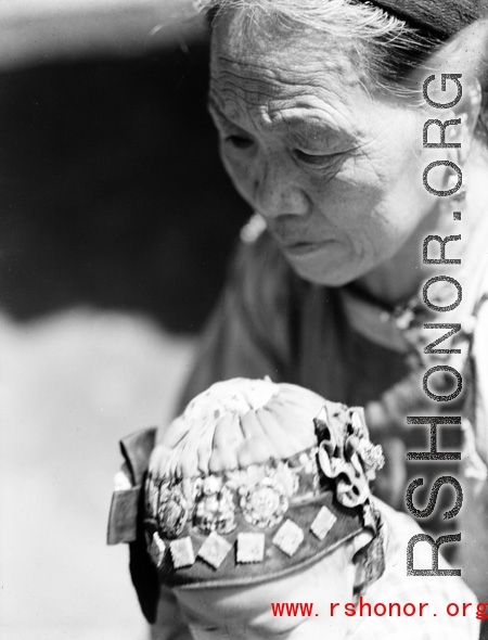 Local people in China: An elderly woman and infant. During WWII.