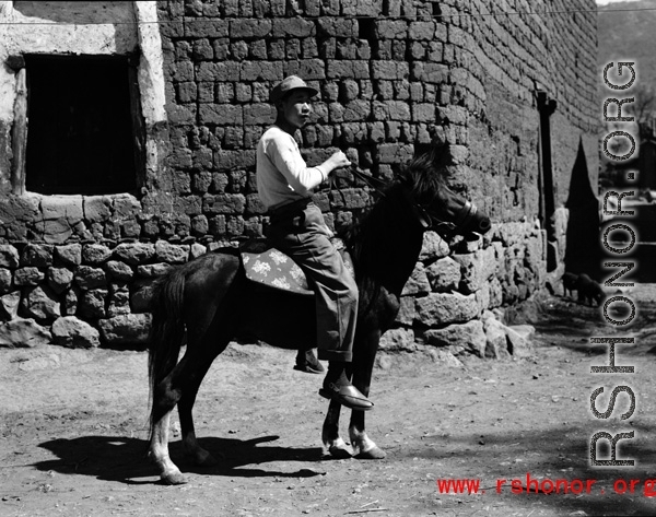 Local people in China: A man in rural China rides a donkey during WWII.  From the collection of Eugene T. Wozniak.
