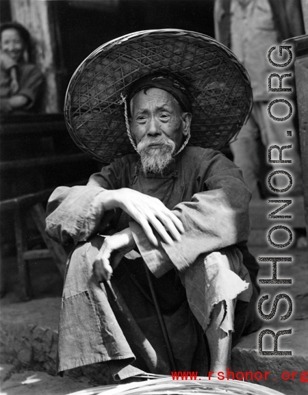 Local people in China during WWII: An elderly man sitting. During WWII.