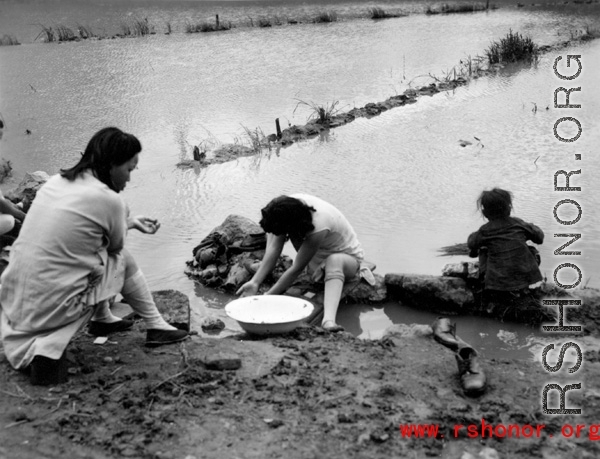 Local women in Yunnan province, China wash clothes by hand during WWII.