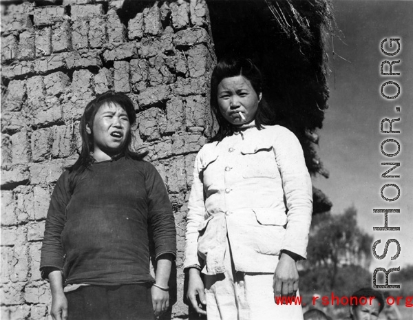 Local women in China during WWII: These are likely to be wives of officers, billeted to live in the village, rather than women who grew up in the village. They also might be prostitutes, following the troops. 