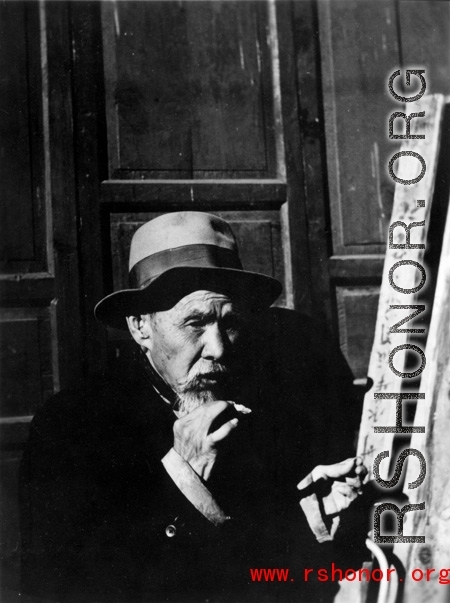 Local people in China: An old man smoking. During WWII.