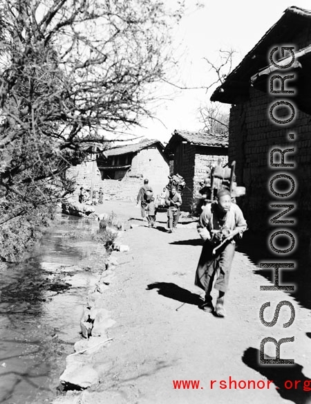 Local people in China: Villagers move around village.  From the collection of Eugene T. Wozniak.