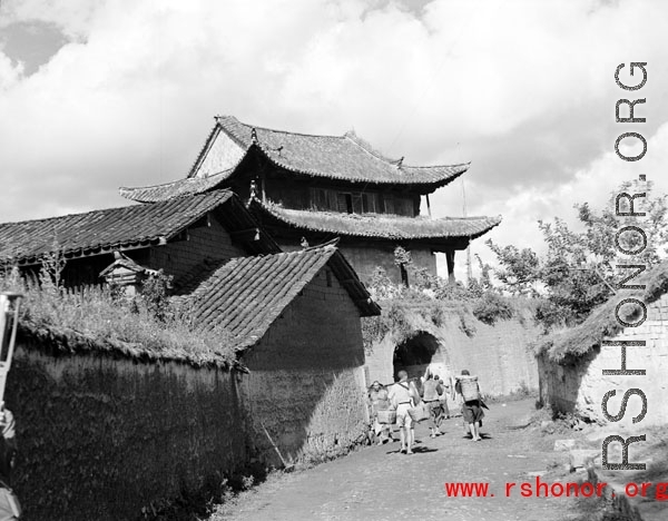 Local people in China: People go through village gate.  From the collection of Eugene T. Wozniak.