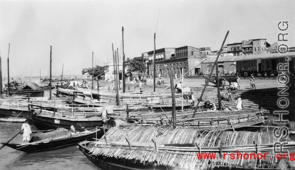 Boats at a mooring, and people, in India during WWII.