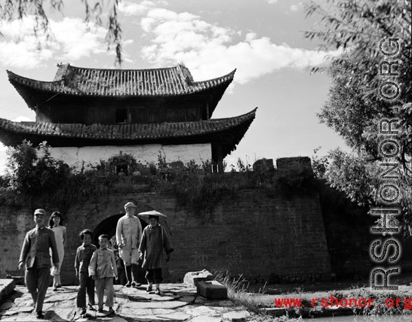 Local people in China in front of a town gate near Yangkai, Yunnan.  From the collection of Eugene T. Wozniak.