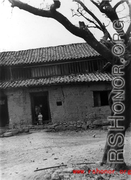 Local people in China--a village home in Yunnan province during WWII.