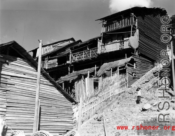 Wooden houses on hillside, either near Kunming in Yunnan province, or in Guilin or Liuzhou in Guangxi province, during WWII.