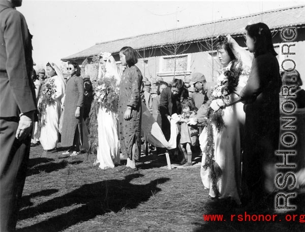 A group wedding in Yunnan province, China, during the hard war years of WWII.  Many of the grooms would have been soldiers and group weddings really came into style at around or just before the war years.