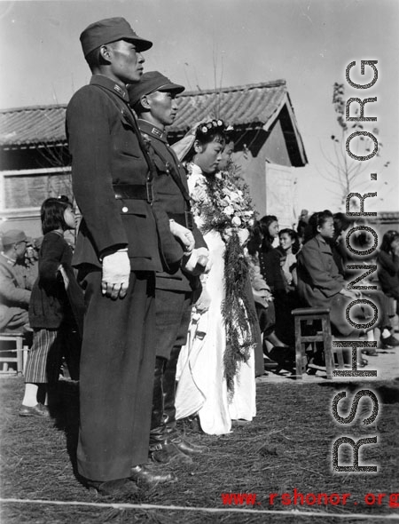 A group wedding in Yunnan province, China, during the hard war years of WWII.  Many of the grooms would have been soldiers and group weddings really came into style at around or just before the war years.
