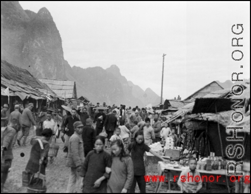 A bustling street at Liuzhou to the south of the river, near the American air base in WWII.  From the collection of Hal Geer.