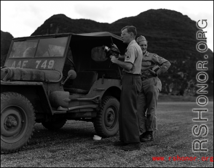 Hal Geer standing near a jeep holding a camera somewhere in Guangxi province, either at Guilin or Liuzhou.