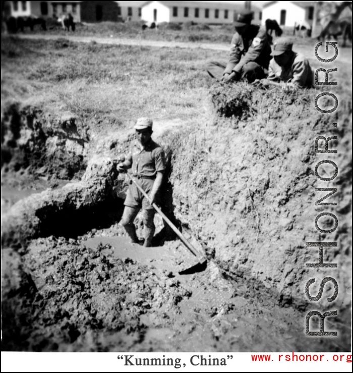 Scenes around Kunming city, Yunnan province, China, during WWII: A Chinese conscript works mud, probably for adobe brick or fired brick making. 