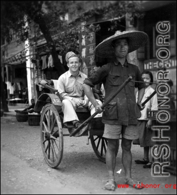 Scenes around Kunming city, Yunnan province, China, during WWII: Rickshaw puller and GI pose for a picture.