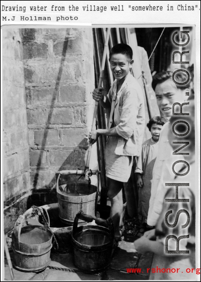 Local people drawing water from a well in China during WWII.  Photo from M. J. Hollman.