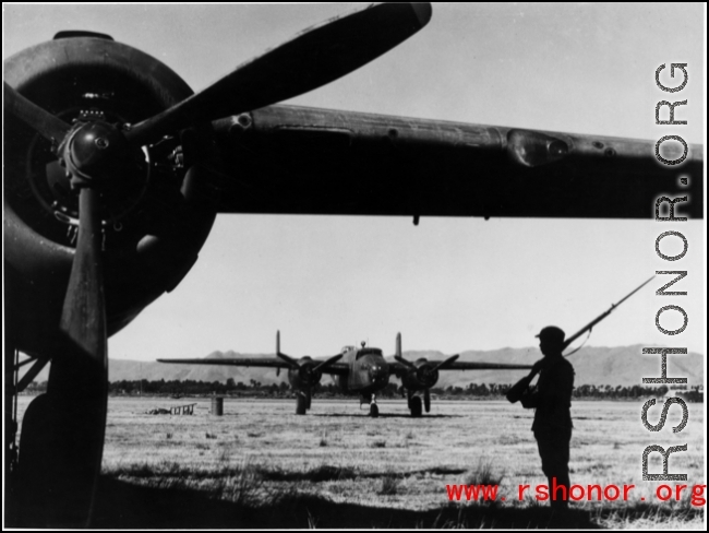 Chinese soldier keeps guard over B-25s in SW China during WWII.