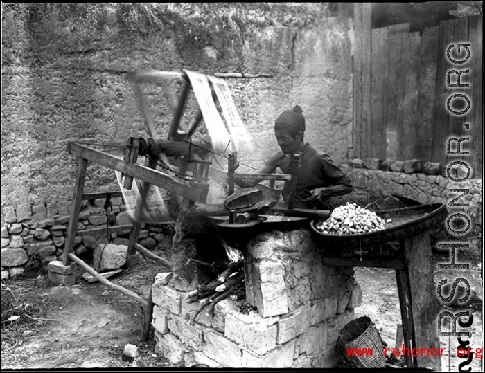A street-side silk spinner, in SW China, during WWII.