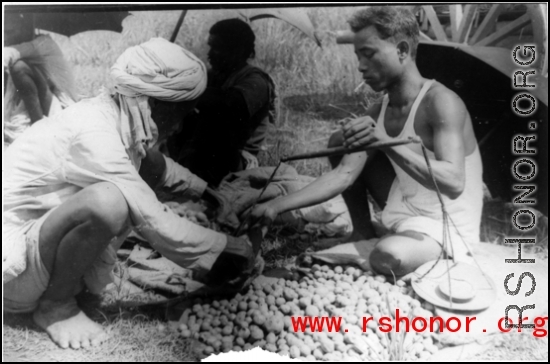 Measuring produce at farmer's market, Misamari, India, during WWII.