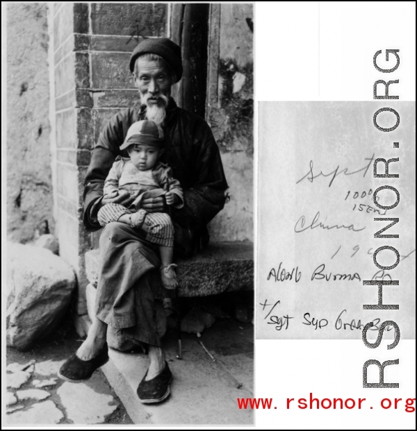 A Chinese elder holds a baby along the Burma Road during WWII, during September 1944.  Photo by T/Sgt. Syd Greenberg.