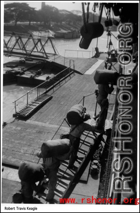 GIs board a ship towards home in the US after the war. In the CBI.  Photo from Robert Travis Keagle.