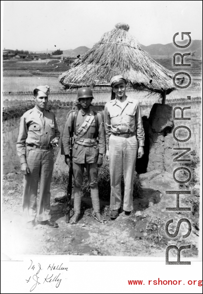 Two GIs (M. J. Hollman and Chaplain J. Kelly) pose with a chinese guard in SW China during WWII.
