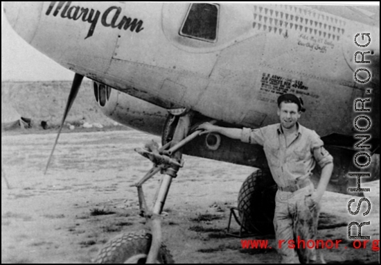 A man poses before the F-5 (a variant of the P-38) 'Mary Ann' piloted by Major H. T. Bailey, who had a crew chief "Snaffy".  Serial #43-26291.