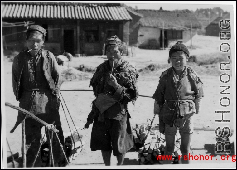 Three firewood peddlers in China during WWII.  Photo from Emery and Beth Vrana.