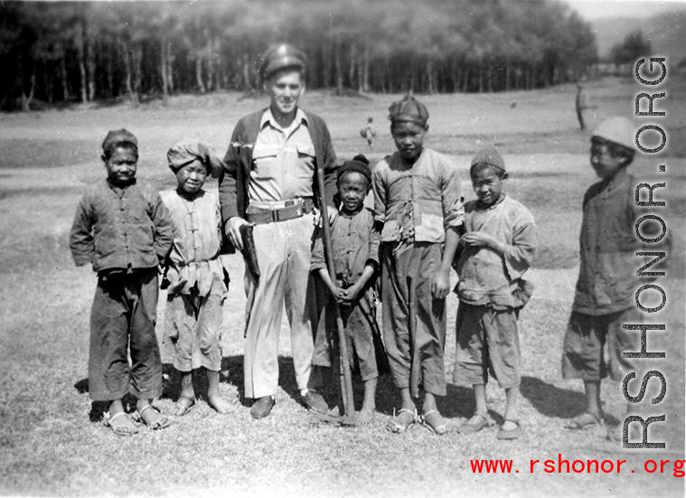Walter Polchlopek with Chinese village kids in the area of Yangkai, Yunnan province, China, during WWII.