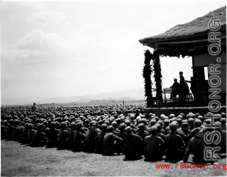 Chinese soldiers sit on ground listening to speech during exercises in southern China, probably Yunnan province, or possibly in Burma.