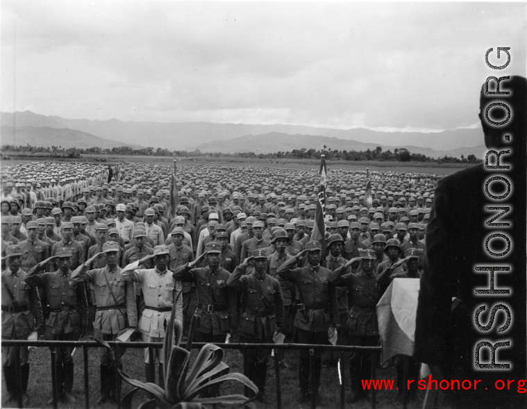 Chinese soldiers stand in ranks during a ceremony during exercises or ceremony in southern China, probably Yunnan province, or possibly in Burma.