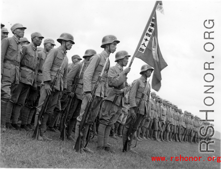 Chinese soldiers  of the 48th Army Division (陆军第四十八师, as noted on banner) stand in rank during rally
