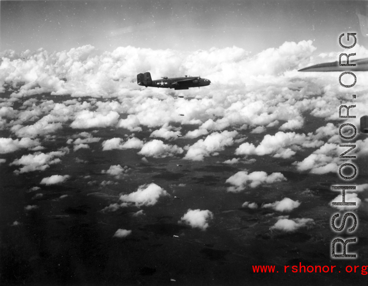 B-25 Mitchell bombers in flight and dropping bombs in the CBI, in the area of southern China, Indochina, or Burma.
