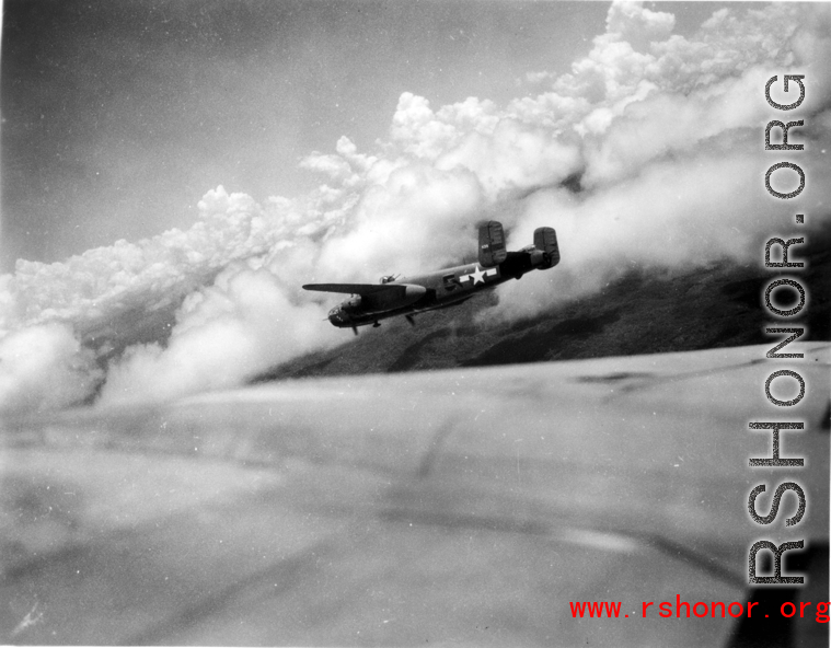 B-25 Mitchell bomber #439 in flight in the CBI, in the area of southern China, Indochina, or Burma.