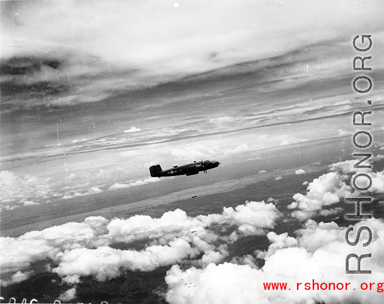 B-25 Mitchell bombers dropping bombs in flight in the CBI, in the area of southern China, Indochina, or Burma.