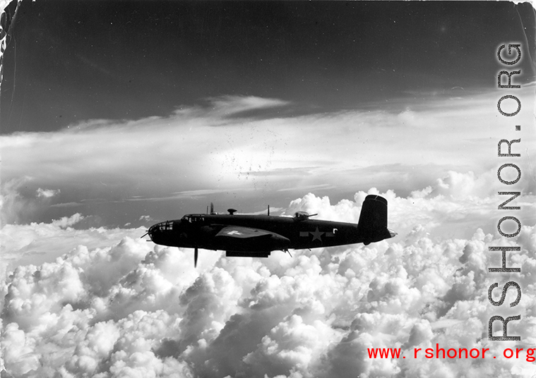 B-25 Mitchell bomber in flight in the CBI, in the area of southern China, Indochina, or Burma. During WWII.