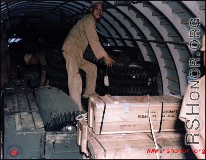 An assortment of supplies, including a four-wheeled vehicle, inside a US C-46 transport plane in the CBI during WWII.