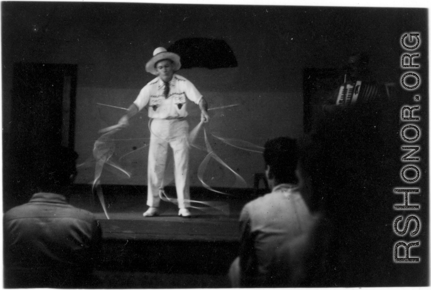 Celebrities visit and perform at Yangkai, Yunnan province, during WWII: Performer does a rope act for  the GIs, as caught by Wozniak in long-exposure photography.