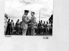 A B-24 bomber crew receives medals for having sunk a 550 foot Japanese cruiser in the South China Sea on August 10, 1944. Here General Chennault pins the Distinguished Flying Cross on 1St. Lst. Lee Cunningham.