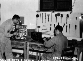Cpl. Provondo and Sgt. Williamson work at the receiver repair bench at Chanyi, China, during the Second World War.   AACS Sta. No. 251, 128th Squadron, Chanyi, China.