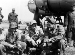 Sgt. Andrew R. Allegretto chats with Chinese airmen, with a B-25 in the background. Sgt. Allegretto received the Air Medal for flying on a hazardous mission as part of the "Spray and Pray Squadron," part of CACW.