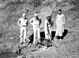 Base personnel inspect a water pump near an American base in Yunnan Province, China, during WWII.